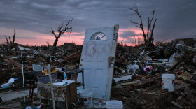 Dawn breaks over the rubble that used to be homes, in this case a door propped up and marked with a street number, left earlier in the week when a tornado hit Moore, Okla., Friday, May 24, 2013. The huge tornado roared through the Oklahoma City suburb Monday, flattening entire neighborhoods with debris-filled winds of up to 200 mph.