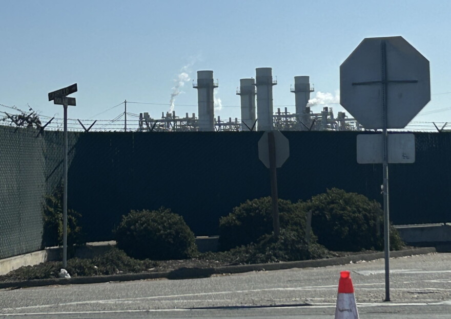 Smoke rises above industrial towers