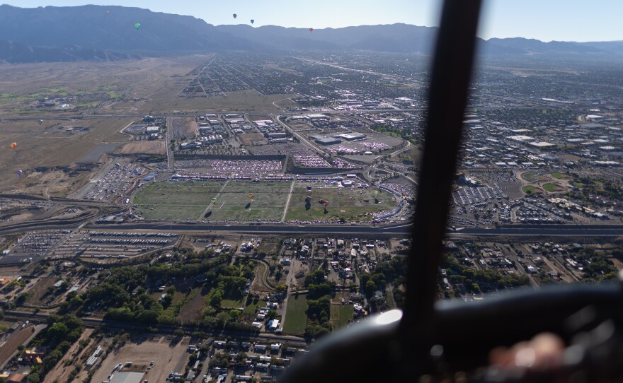 An airborne view of the Balloon Fiesta Park. Pilots navigate their balloons by controlling altitude (going up or down) to find different wind currents.
