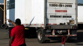 FILE - A student driver helps his classmate steer the wheel into the right direction as they practice driving in reverse in Calif., Nov. 17, 2021. (AP Photo/Jae C. Hong, File)