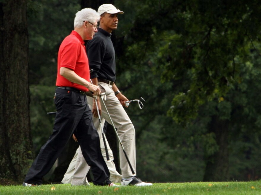 Presidents Clinton and Obama during a round of golf last September.