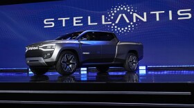 FILE - The Ram 1500 Revolution electric battery powered pickup truck is displayed on stage during the Stellantis keynote at the CES tech show on Jan. 5, 2023, in Las Vegas. Tensions rose in contract talks between the United Auto Workers union and Stellantis on Tuesday, Aug. 8, with the union president accusing the company of seeking concessions in contract talks when the union wants gains, as a September strike threat looms. (AP Photo/John Locher, File)