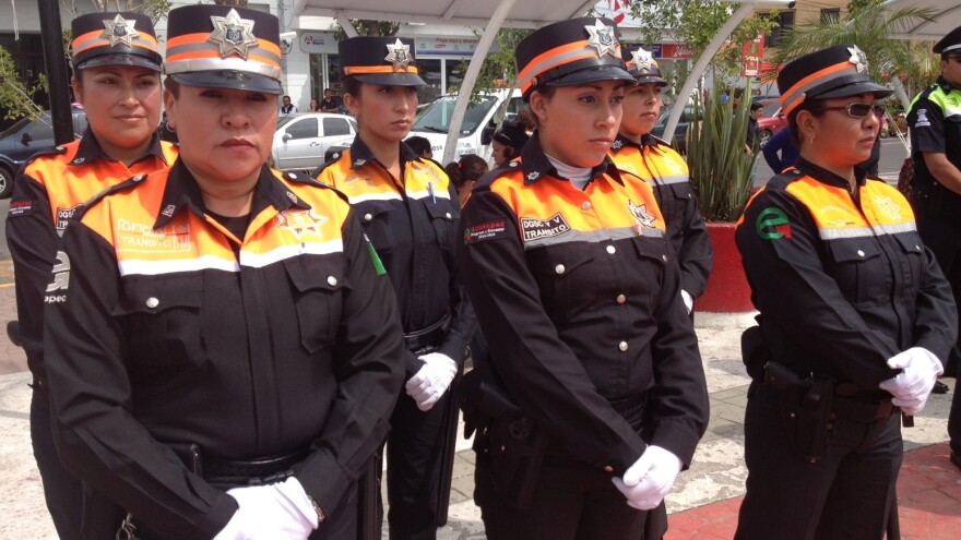 Dressed in the black and neon orange colors of the new transit police, these women are slated to replace a force of notoriously corrupt traffic cops in Mexico State.