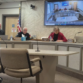 Claire Hall (center) at a commissioner meeting