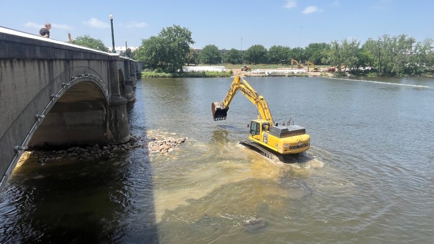 Equipment moves into the Grand River Wednesday as rapids restoration project begins