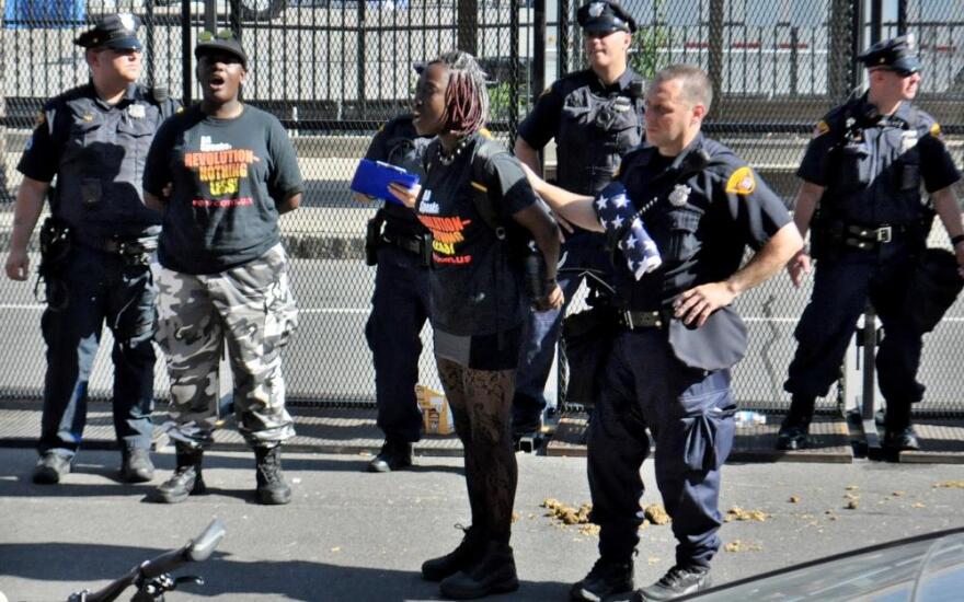 Two members of the Revolutionary Communist Party being arrested after the flag burning. (Matt Richmond)  