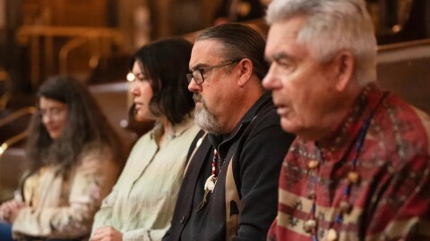 Four people sitting in a row.