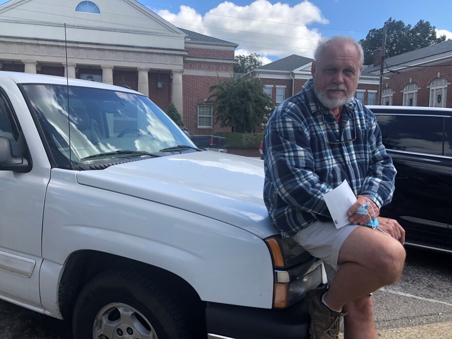 David Quinn, 64, leans against a car outside the post office in Oxford, the seat of Granville County.