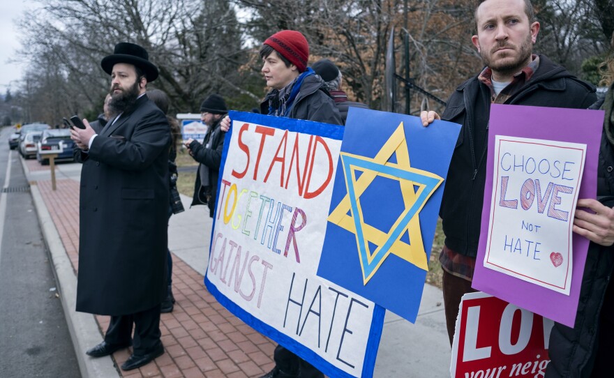 Neighbors gather to show their support of the community near a rabbi's residence in Monsey, N.Y., on Sunday.