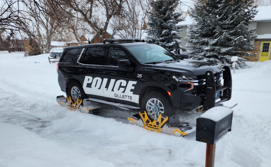 A Gillette Police Department vehicle with snow tracks patrols in a residential neighborhood. The tracks have proven helpful in deep snow conditions and can be installed in two hours or less.