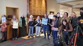 Protesters outside a NM Public Regulation Commission meeting February 17 at the University of New Mexico. The PRC was seeking public input on a controversial deal between private equity firm Blackstone Infrastructure and the Public Service Company of New Mexico's parent company, TXNM.