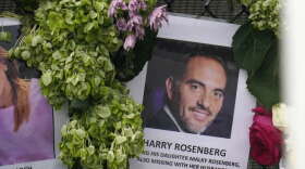 FILE - In this June 29, 2021, file photo, an image of Harry Rosenberg, missing since an oceanfront condo building collapsed in Surfside, Fla., hangs on a fence as part of a makeshift memorial. After losing his wife to cancer and his parents to COVID-19, Rosenberg’s new home came with the promise of a fresh start. His daughter, Malky Weisz. and her husband, Benny Weisz, had just arrived for a visit and are also missing. (AP Photo/Gerald Herbert, File)