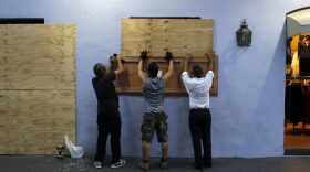 People board up windows of a business in preparation for the anticipated arrival of Hurricane Maria in San Juan, Puerto Rico on Sept. 18, 2017. Hurricane Maria has grown into a maximum-strength Category 5 storm, US forecasters said Monday, as it was bearing down on the Caribbean island of Dominica. (Ricardo Arduengo/AFP/Getty Images)
