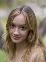 A woman with blonde hair smiling facing the camera