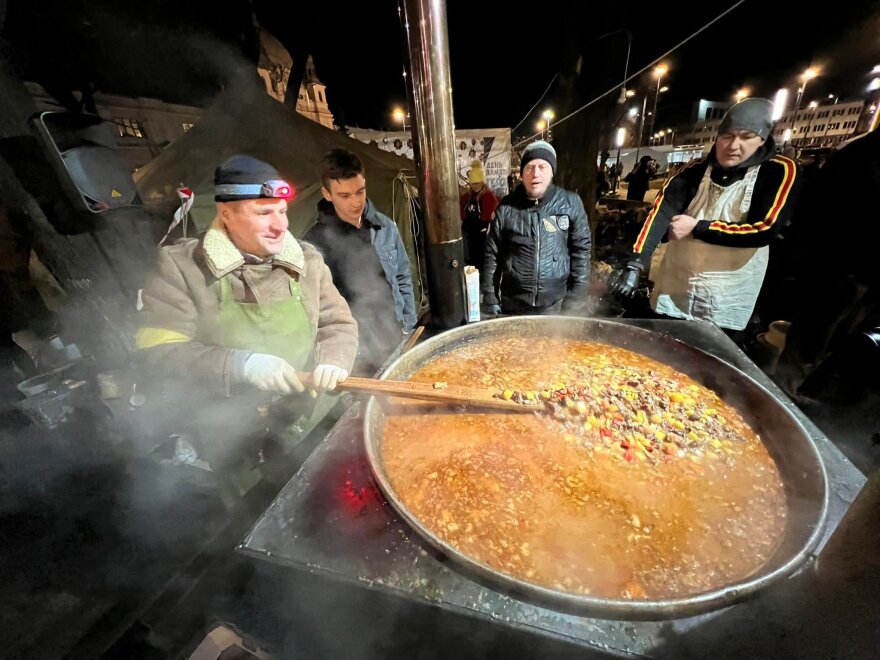 Volunteers help prepare soup for Ukrainian refugees.