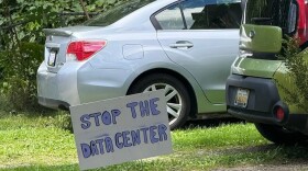 A handmade sign in a yard reading "stop the data center."