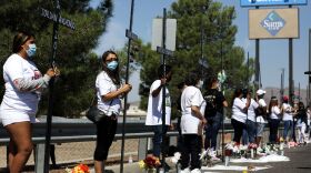 Mourners hold 23 crosses Monday in front of a Walmart honoring those killed in the 2019 attack in El Paso, Texas.