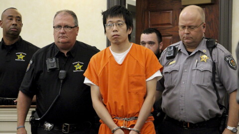 Tailei Qi, the graduate student suspected in the fatal shooting of a University of North Carolina at Chapel Hill faculty member, center, makes his first appearance at the Orange County Courthouse in Hillsborough, N.C., Tuesday, Aug. 29, 2023. Qi has been charged by the UNC Police Department with first-degree murder and possession of a weapon on educational property, both felony charges.