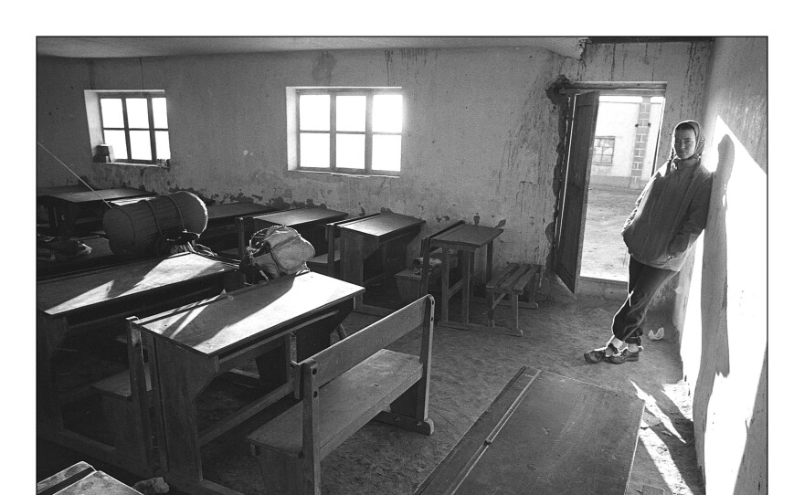June Siple relaxes in a Bolivian schoolhouse, where she and Greg Siple overnighted with local permission given. As the poorest population overall that they came across, most Bolivians also lived in a harsh environment.