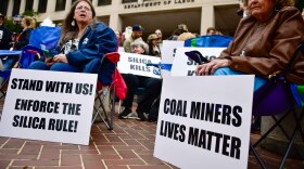 Former coal miners and families of deceased ones held a rally outside the Department of Labor in October, urging the administration to defend and enforce a safety rule that limits worker exposure to toxic silica dust.