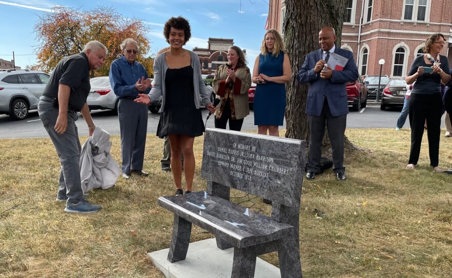 Mt. Vernon High School Senior Sophie Kloppenburg smiles after the memorial bench is uncovered