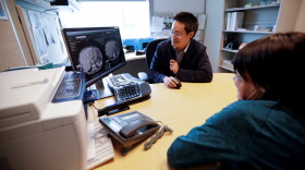 A patient looks at images with her doctor in this file photo.