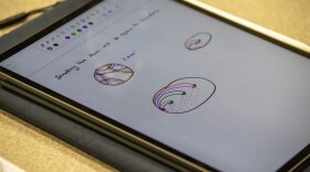 A math lesson is shown on a digital tablet.