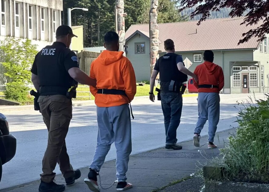 Petersburg police officers escort Shubham Patel, 24, and Harshilkumar Patel, 22, from the Petersburg Courthouse after their June 10, 2025 joint first appearance on felony fraud charges.