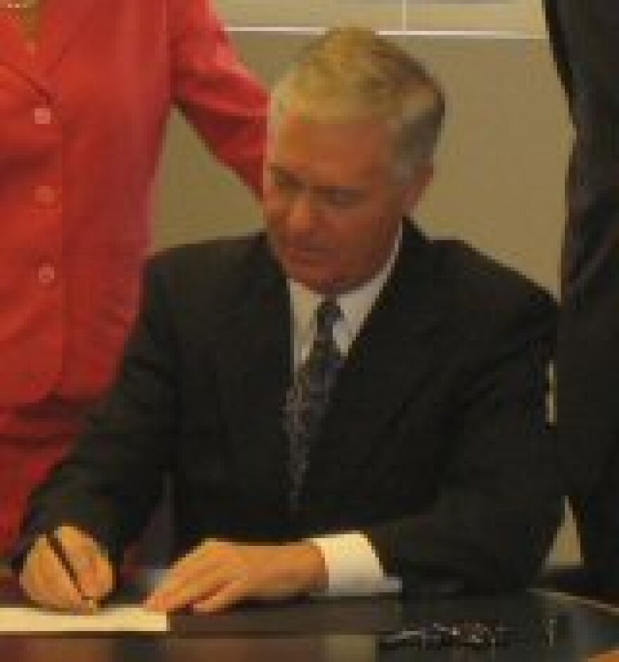 Easely signing the landfill moratorium.