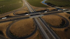 FILE - Freight trucks travel northbound on Interstate 5 Highway, Sept. 3, 2025, in Tracy, Calif.