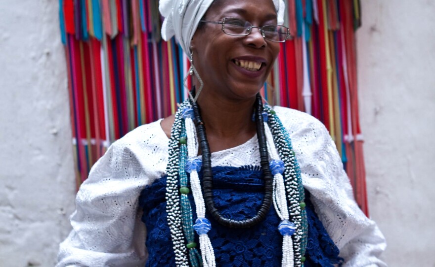 A Candomblé practitioner gets ready for the party outside the temple.