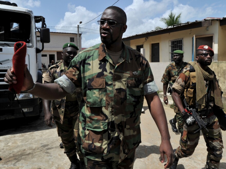 Ibrahim Coulibaly walks in the Abobo neighborhood of Abidjan on Tuesday. Coulibaly says he's the head of a militia called the Invisible Commando. The group fought against former President Laurent Gbagbo's forces, but has not joined the newly renamed army, the Republican Forces of Ivory Coast.