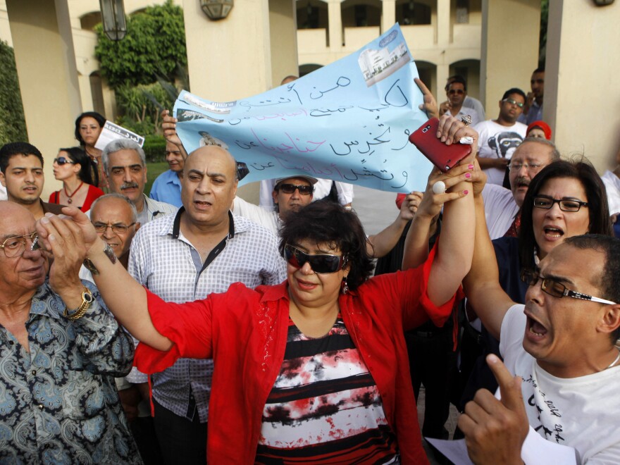 Enas Abdel-Dayem, former head of the Cairo Opera House (center), is greeted by employees and activists on May 30 as they chant anti-Muslim Brotherhood slogans during a protest demanding the resignation of Egypt's culture minister.