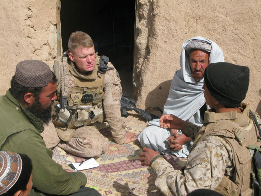 Marine Lt. Col. Brian Christmas listens as an interpreter translates the concerns of Marjah residents about opening a school. Local people fear the Taliban who have remained in the area, hidden among the population. Some residents have received "night letters" — notes from Taliban fighters threatening them with death if they deal with NATO or Afghan government troops.