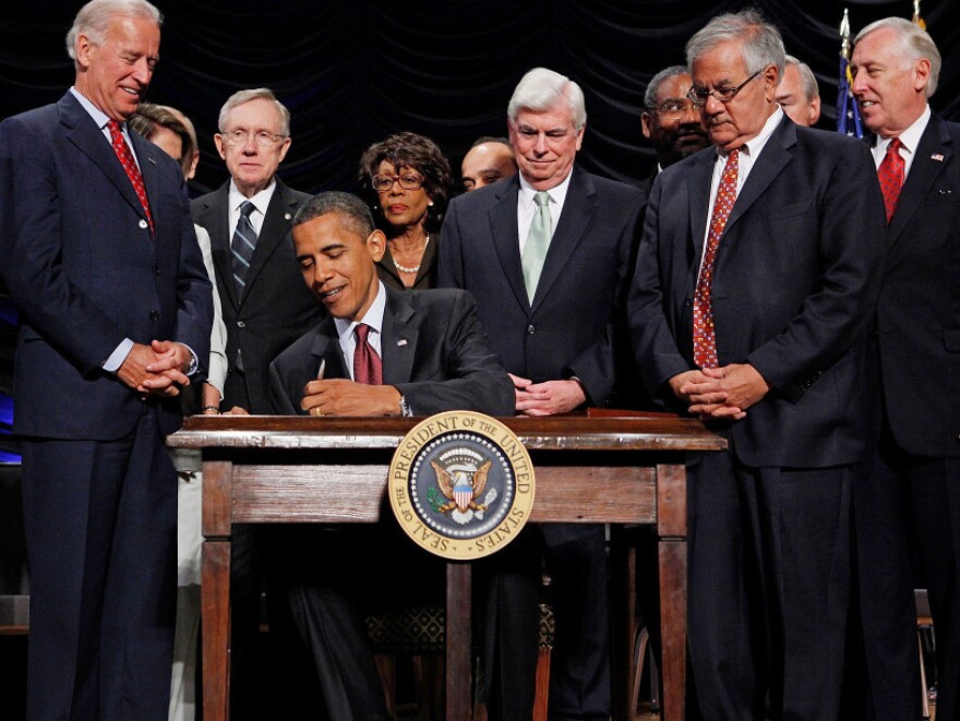 President Obama signs the financial reform bill into law, July 21, 2010. Vice President Joe Biden, Senate Majority Leader Harry Reid (D-NV), then Senate Banking Chairman Christopher Dodd (D-CT), House Financial Services Committee Chairman Barney Frank (D-MA) and other lawmakers look on.