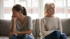 In quarrel elderly mother grown up daughter sit on couch separately having conflict, intergenerational misunderstanding, adult grandchild grandma difficult bad relations different generations concept