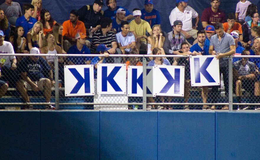 Five cardboard signs hang in the left field of Mckethan Stadium, representing Florida starter Logan Shore's strikeout count against FSU on June 5.