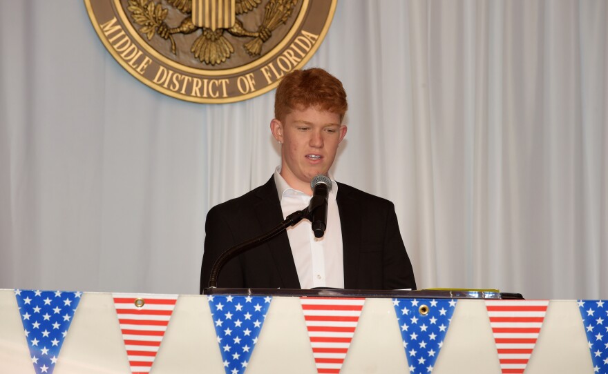 Noah Moon reads his essay at the Fort Myers Courthouse