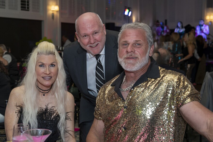 Amanda and Mark Mosely with (center) Frank Valente, president & CEO of the Humane Society of the Treasure Coast
