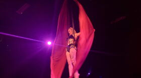 Georgia Ackerman opens the show as Lady Firefly on the aerial silks.