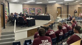 School board meeting July 13, members of Elite Community Outreach sit in the audience.