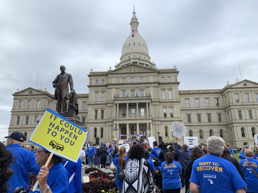 Thousands rally at the state Capitol against the state’s new auto insurance law.