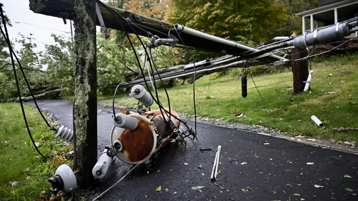 Power lines and tree branches cover a sidewalk in Mansfield, Connecticut. during a nor’easter on Sept. 27, 2026.