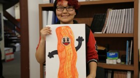 LKSD student Dorothy Jackson from Nightmute shows her Halloween costume design for a salmon strip that looks like bacon.