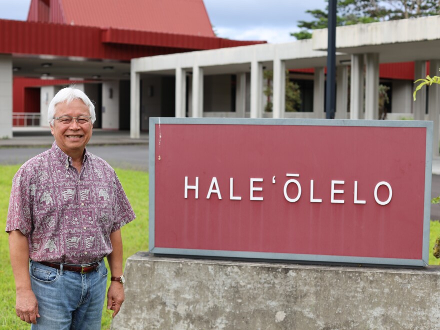 Kimura, seen standing in front of the college where he teaches, believes that the Hawaiian language is still endangered and will take a few more generations to be strong enough to survive.