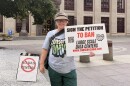Conserve Ohio volunteer Kim Kinder-Smith stands outside Columbus City Hall on July 22, 2026 ahead of a public hearing on proposed data center regulations in the city. Kinder-Smith was gathering signatures for a measure to ban large data centers.