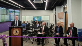 U.S. Senator Dick Durbin (at the podium) addresses the crowd at the ribbon-cutting ceremony. Jamie Johnson, Director of the School of Law Enforcement and Justice Administration; WIU President Kristi Mindrup; and Macomb Mayor Mike Inman (seated left to right in the foreground) were also there along with faculty and students seated in the background.