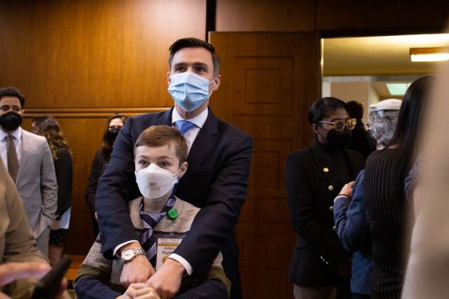 Oregon House Speaker Dan Rayfield celebrates the adjournment of the 2022 legislative session with his son Adam and colleagues from both chambers Friday, March 4, 2022.