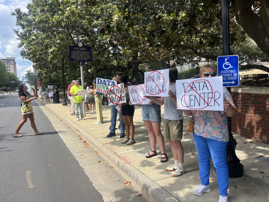 Protesters hold signs opposing Rural Hall data center