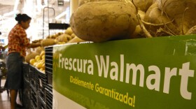 A shopper examines produce at a Wal-Mart store in Mexico City. Wal-Mart's expansion into Mexico has been a major success, but its business practices have raised new questions.